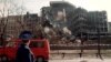 A member of a Russian delegation visiting Belgrade in April 1999 looks at the building of the Serbian Interior Ministry which was totally destroyed in overnight NATO bombing.