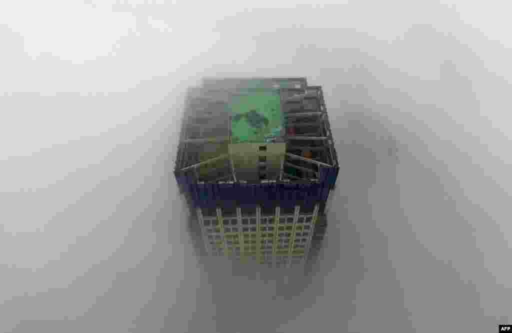 A building appears through a thick layer of fog in Yangzhou, in China's eastern Jiangsu Province. (AFP)