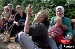 Srebrenica refugees weep over the loss of their men in Tuzla in July 1995 after they were evacuated from Potocari.