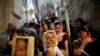 Orthodox Christian worshippers hold crosses as they take part in a Good Friday procession in the Church of the Holy Sepulchre in Jerusalem&#39;s Old City on April 6. (Reuters/Corinna Kern)