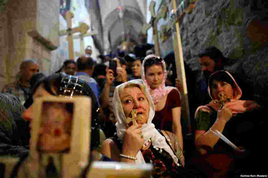 Orthodox Christian worshippers hold crosses as they take part in a Good Friday procession in the Church of the Holy Sepulchre in Jerusalem's Old City on April 6. (Reuters/Corinna Kern)