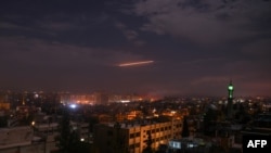 A picture taken early on January 21, 2019 shows Syrian air defense batteries responding to what the Syrian state media said were Israeli missiles targeting Damascus. File photo