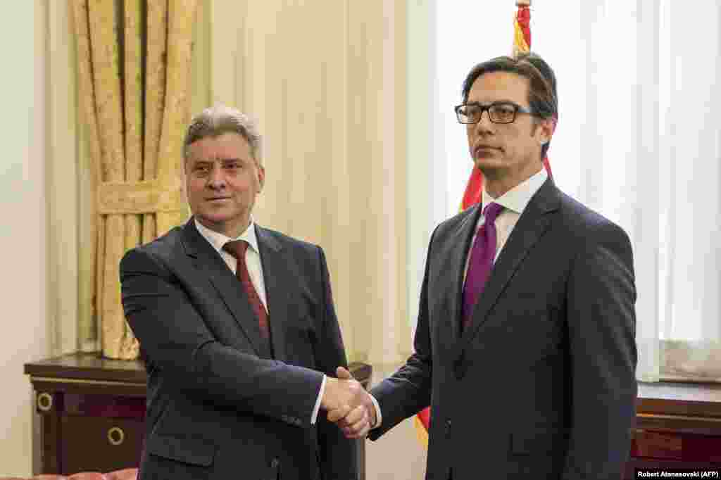 New elected President of North Macedonia Stevo Pendarovski (R) shakes hands with former President Gjorge Ivanov (L) during a ceremony to hand over duties, upon his arrival at the presidential palace in Skopje on May 12, 2019. (Photo by Robert ATANASOVSKI / AFP)