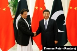 Chinese President Xi Jinping shakes hands with Pakistani Prime Minister Imran Khan before their meeting at the Great Hall of the People in Beijing in April 2019.
