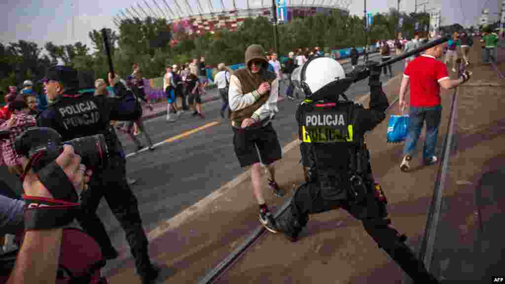 Riot police react after Polish and Russian football fans clash in Warsaw.