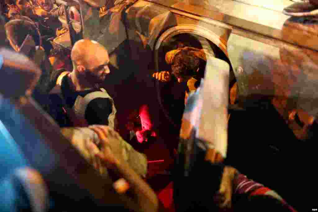 Turkish police arrest Turkish soldiers on Taksim Square in Istanbul.