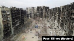 An aerial view shows residential buildings in the southern Ukrainian port city of Mariupol damaged by Russian attacks.