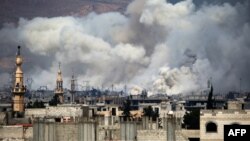 Smoke billows following reported air strikes by Syrian government forces on Damascus's northeastern rebel-held Al-Qaboun surburb on March 15.