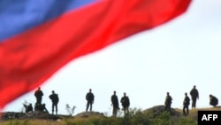 Russian soldiers await their departure from a checkpoint in a breakaway region of Georgia in 2008, when the countries fought a brief but deadly war.