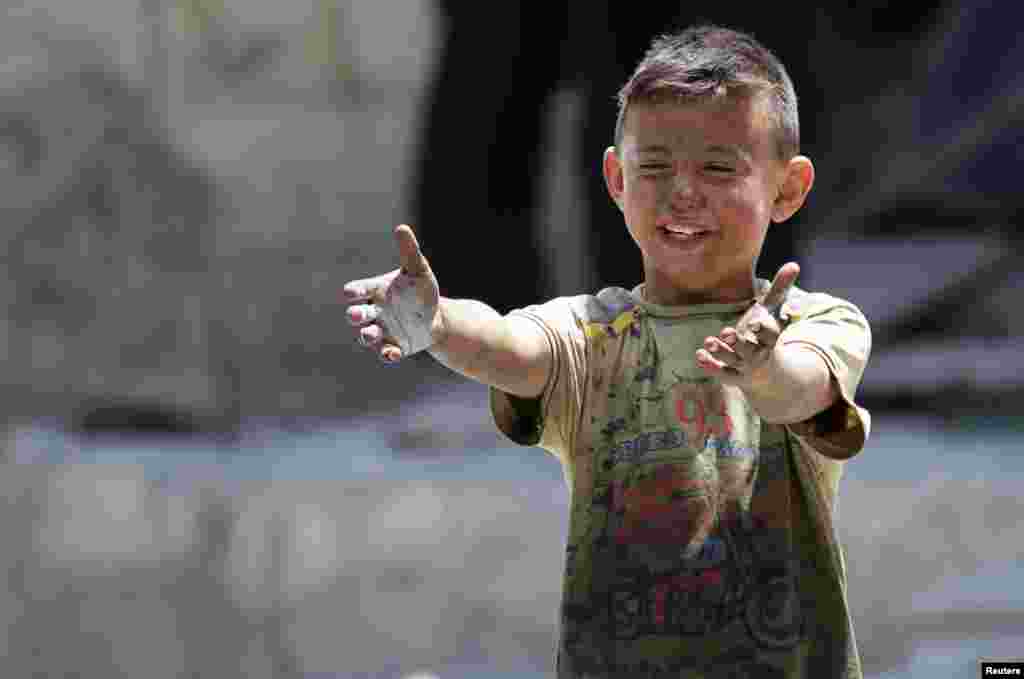 A boy, whose brother was killed, reacts at a site hit by airstrikes in the rebel-controlled area of Maaret al-Numan town in Idlib province, Syria. (Reuters/Khalil Ashawi)