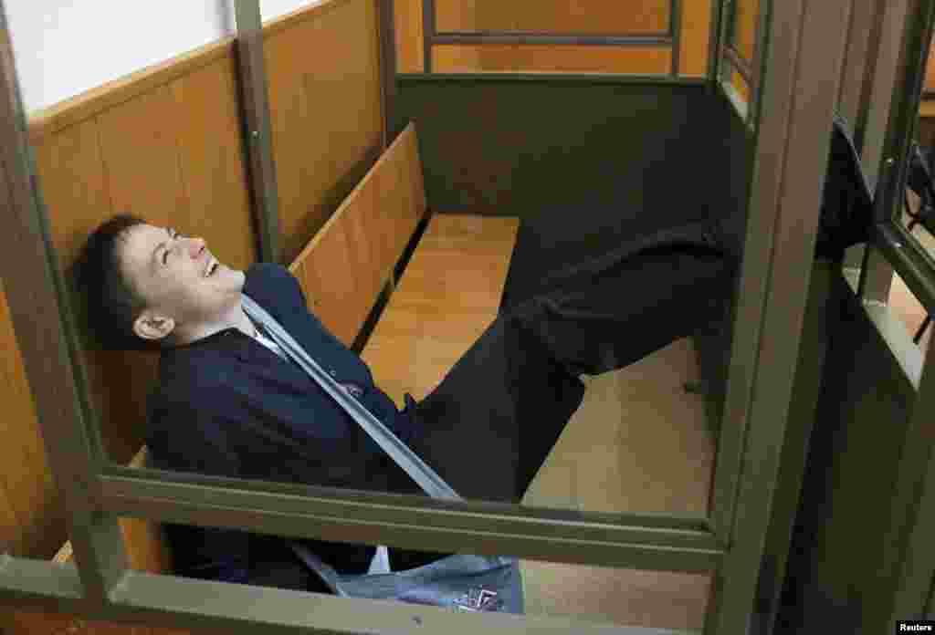 Ukrainian Army pilot Nadia Savchenko reacts from a glass-walled cage during a verdict hearing at a court in the southern border town of Donetsk in Russia's Rostov region. She was sentenced to 18 years for complicity in the deaths of two Russian journalists during fighting in eastern Ukraine in June 2014. She was sentenced to 10 years for complicity in the attempted killings of other civilians in the same incident. (Reuters/Maxim Shemetov) 