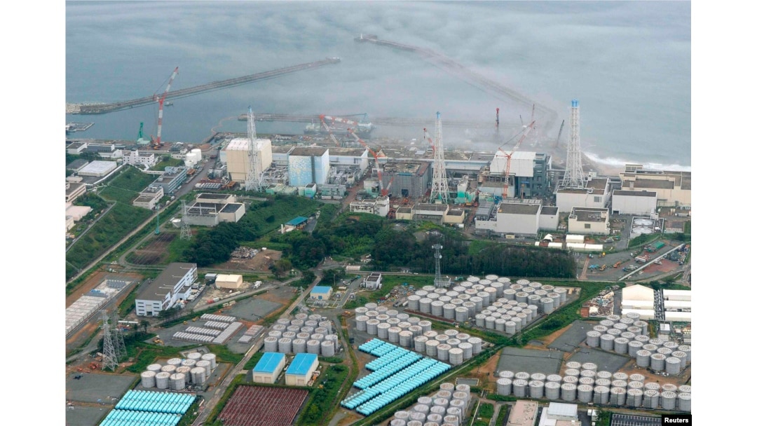 An aerial view of the Fukushima plant and its contaminated-water storage tanks (bottom)