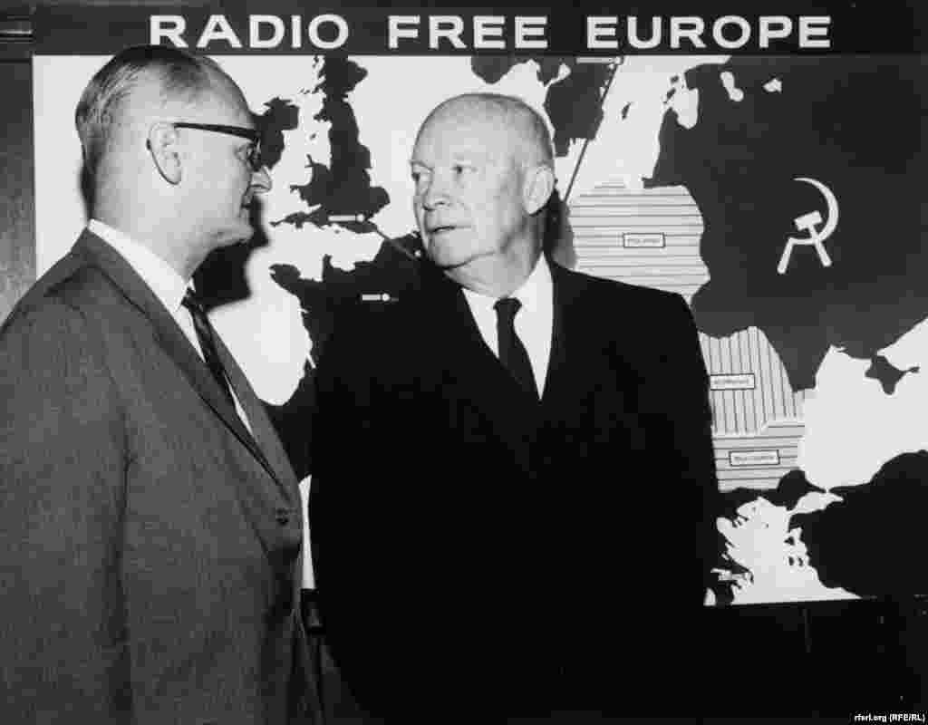 U.S. President Dwight D. Eisenhower talks with RFE director C. Rodney Smith in front of a map showing RFE's broadcasting area in the early 1960s.