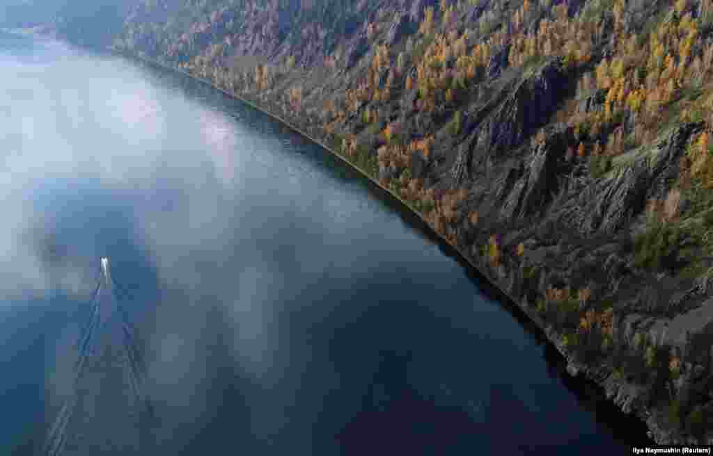 A boat travels on the Yenisei River in the Siberian Taiga area outside Krasnoyarsk, Russia. (Reuters/Ilya Naymushin)