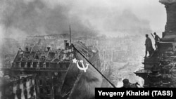 Yevgeny Khaldei's iconic photo of Red Army soldiers hoisting the Soviet flag over the Reichstag in May 1945.