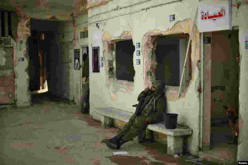 A Palestinian man dressed in an Israeli soldier's uniform is seen inside a prison in Gaza City that had been used by Israeli security services to keep Palestinian prisoners during Israel's occupation of the Gaza Strip. A Hamas prisoners' association has turned the place into an exhibition. (Reuters/Suhaib Salem)