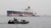 IRAN -- An Iranian military speedboat patrols the waters as a tanker prepares to dock at the oil facility in the Khark Island, March 12, 2017