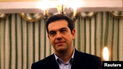 Greece -- Newly appointed Greek Prime Minister and winner of the Greek parliamentary elections, Alexis Tsipras, attends a swearing in ceremony by members of his cabinet at the presidential palace in Athens January 27, 2015.