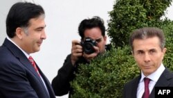 Georgia -- President Mikheil Saakashvili (L) greets the leader of Georgian Dream opposition coalition Bidzina Ivanishvili as they meet in Tbilisi, 09Oct2012