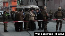 Security personnel inspect the site of suicide attack in Kabul on March 13 that targeted a minibus carrying employees of a telecom firm.