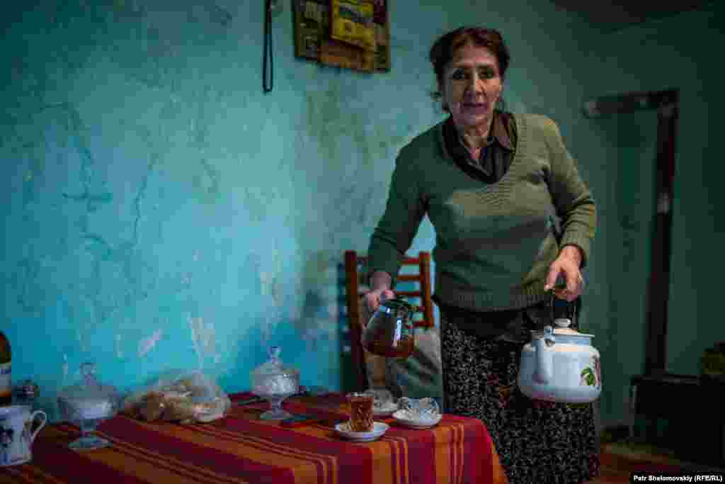 Suzanna Bakhyshova in her house on the edge of the oil field in the Binagady district of Baku. The house has no running water and no sewage system. 