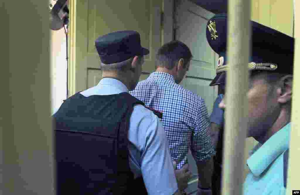 Aleksei Navalny leaves the courtroom.