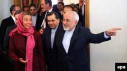 Iranian Foreign Minister Mohamad Javad Zarif (R) welcomes EU foreign policy chief Federica Mogherini (L) to Tehran, July 28, 2015