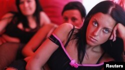 Romanian prostitutes pose in a German brothel -- the UN says two-thirds of profits in forced labor come from the sexual exploitation of women and girls. 