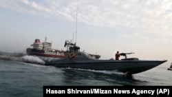 A speedboat of the Iran's Revolutionary Guard moves around a British-flagged oil tanker Stena Impero, which was seized on Friday by the Guard, in the Iranian port of Bandar Abbas, July 21, 2019