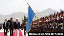 Afghan President Ashraf Ghani (third from left) inspects guards of honor as he arrives at the Afghan parliament in Kabul. (file photo)