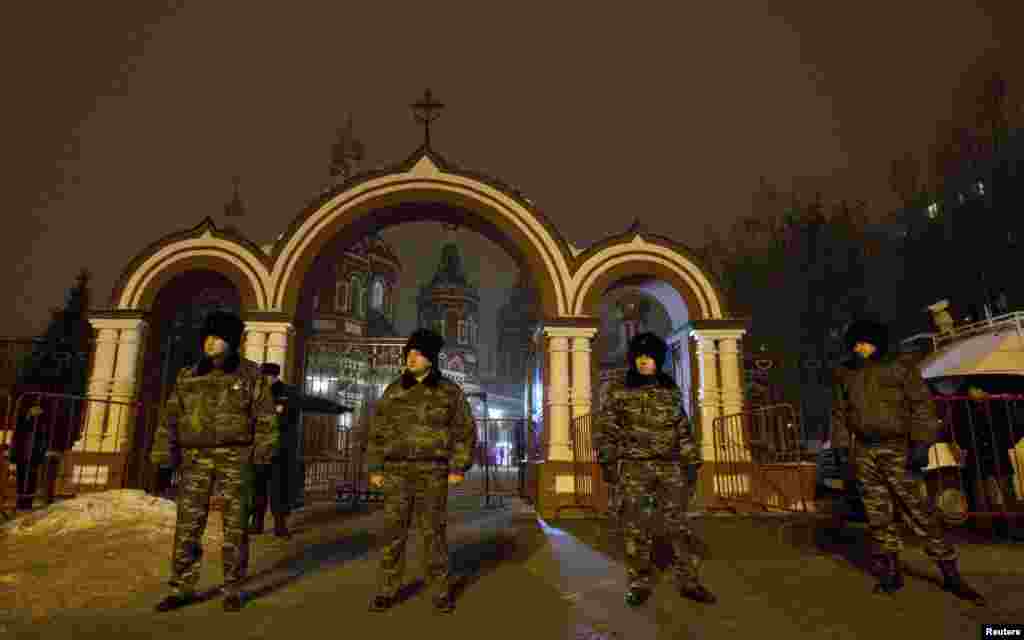 Cossacks, who started regular patrols within the city of Volgograd in the wake of recent suicide attacks, stand guard in front of the Kazan Orthodox Cathedral. (Reuters/Vasily Fedosenko)