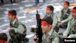 Basij militia schoolboys take part in a rally outside the former U.S. Embassy in Tehran in a file photo from November 2010.