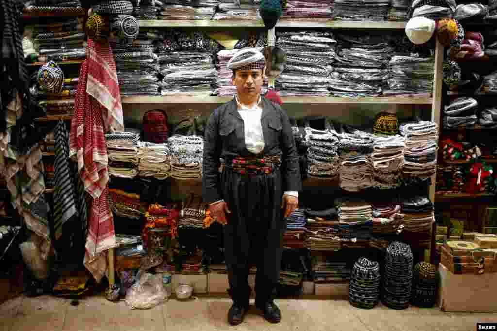 Crafts salesman Hidaya Muhyiddin, 35, poses for a photograph in Irbil, the capital of Iraq's autonomous Kurdish region. (Reuters/Azad Lashkari)
