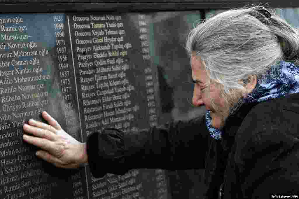 A woman cries at a commemorative monument in Baku, Azerbaijan, during a rally to mark the 27th anniversary of the Khojaly Massacre in Nagorno-Karabakh in 1992. (AFP/Tofik Babayev)