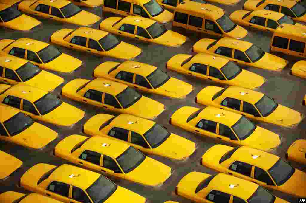 OCTOBER 30, 2012 -- Taxis sit in a flooded lot after Hurricane Sandy in Hoboken, New Jersey. (Michael Bocchieri/Getty Images/AFP)