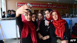 Members of the Afghan robotics team prepare to leave Herat International Airport for the United States on July 13.