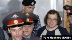 Disgraced Russian entrepreneur Sergei Mavrodi (center right) says he wants to destroy the "unfair" global financial system.