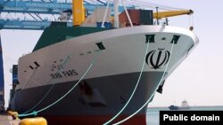 Iran - An Iranian container ship cruises in a cargo area of a port . UNDATED