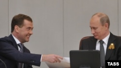 Russian President Vladimir Putin (right) with Dmitry Medvedev at a special session of the State Duma in Moscow, which confirmed Medvedev's appointment as prime minister.