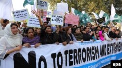 Pakistanis attend a "peace walk" in the city of Lahore last month, after representatives of Pakistan and the Taliban met for the first time since the government suspended the peace process over the killing of 23 soldiers by the rebels. 