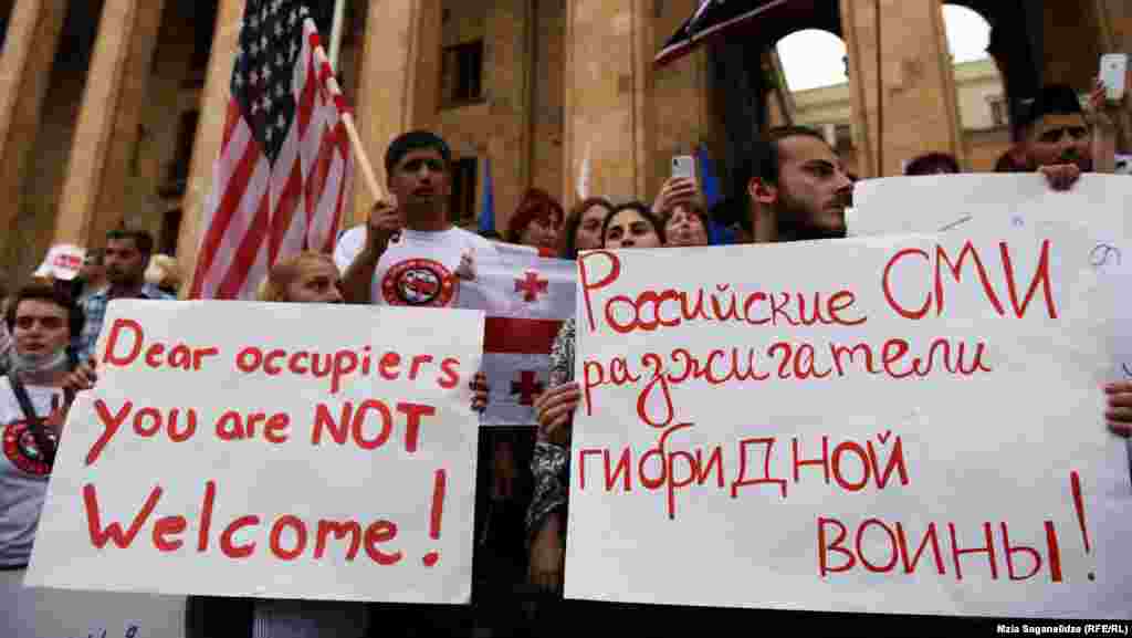 Protesters hold signs referring to Russians as occupiers, a frequent reaction to Gavrilov's appearance in parliament. Georgians view Gavrilov as an ally of Putin and say he backs Russian support for the breakaway regions of South Ossetia and Abkhazia.