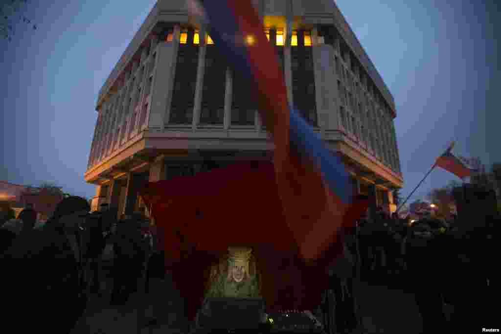 A pro-Russian DJ in traditional clothing looks at her computer during a rally outside the Crimean parliament building in Simferopol, Ukraine, on February 27. (Reuters/Baz Ratner)