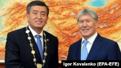 Kyrgyz President Sooronbai Jeenbekov (left) shakes hands with former President Almazbek Atambaev in Bishkek on November 24, 2017.