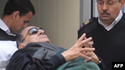 Egypt -- Former president Hosni Mubarak, lies on a stretcher as he leaves court following his trial at police academy, on the outskirts of Cairo, 02Jan2011