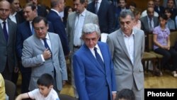 Armenia -- Newly appointed Energy Minister Levon Yolian (far left) accompanies President Serzh Sarkisian (in the center) at a chess tournament in Yerevan (archive footage)