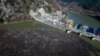 Bosnia Balkans Pollution -- This is aerial photo shows plastic bottles, wooden planks, rusty barrels and other garbage clogging the Drina river near the eastern Bosnian town of Visegrad, Bosnia, Tuesday, Jan. 5, 2021. 