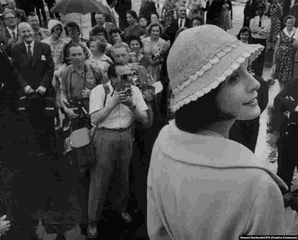 Model Kouka Denis attracts a crowd during the trip. Denis later said some people &quot;were touching us with their fingers to see if we were real, to check that we were not dolls.&quot;