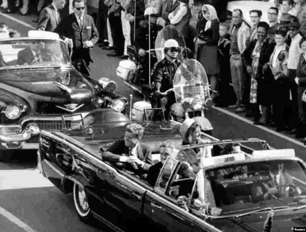 President Kennedy and his wife Jacqueline ride in the motorcade through the city of Dallas just moments before the president was assassinated on November 22, 1963.