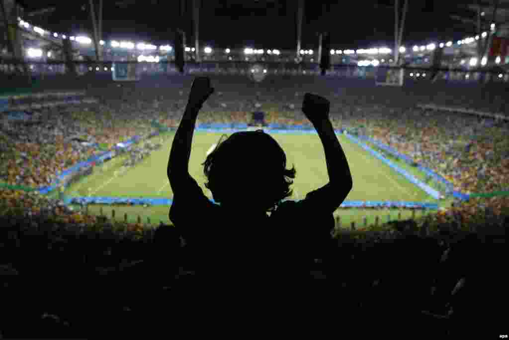 Five-year-old Joaquim Villano of Rio de Janeiro celebrates on the shoulders of his uncle after Brazil defeated Germany in the men's soccer gold medal match. In front of 78,000 at Rio’s Maracana Stadium, Neymar fired the winning goal as Brazil beat Germany 5-4 on penalties.