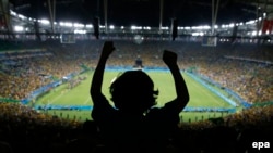 Five-year-old Joaquim Villano of Rio de Janeiro celebrates on the shoulders of his uncle after Brazil defeated Germany in the men's soccer gold-medal match at the Rio 2016 Olympic Games.